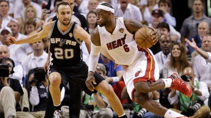 Lebron James powered a frantic fourth-quarter rally and overtime escape as the Miami Heat beat the Spurs - to extend the NBA Finals.